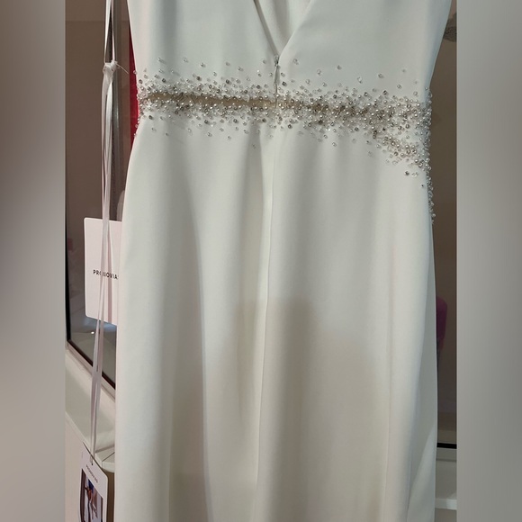 Pronovias Alaia is a striking crepe wedding dress featuring linear beading. - Picture 10 of 11